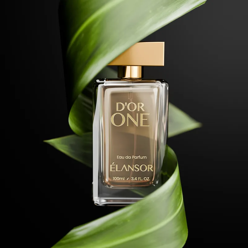 D’Or One Eau de Parfum bottle framed by green leaves, a long-lasting woody spicy perfume